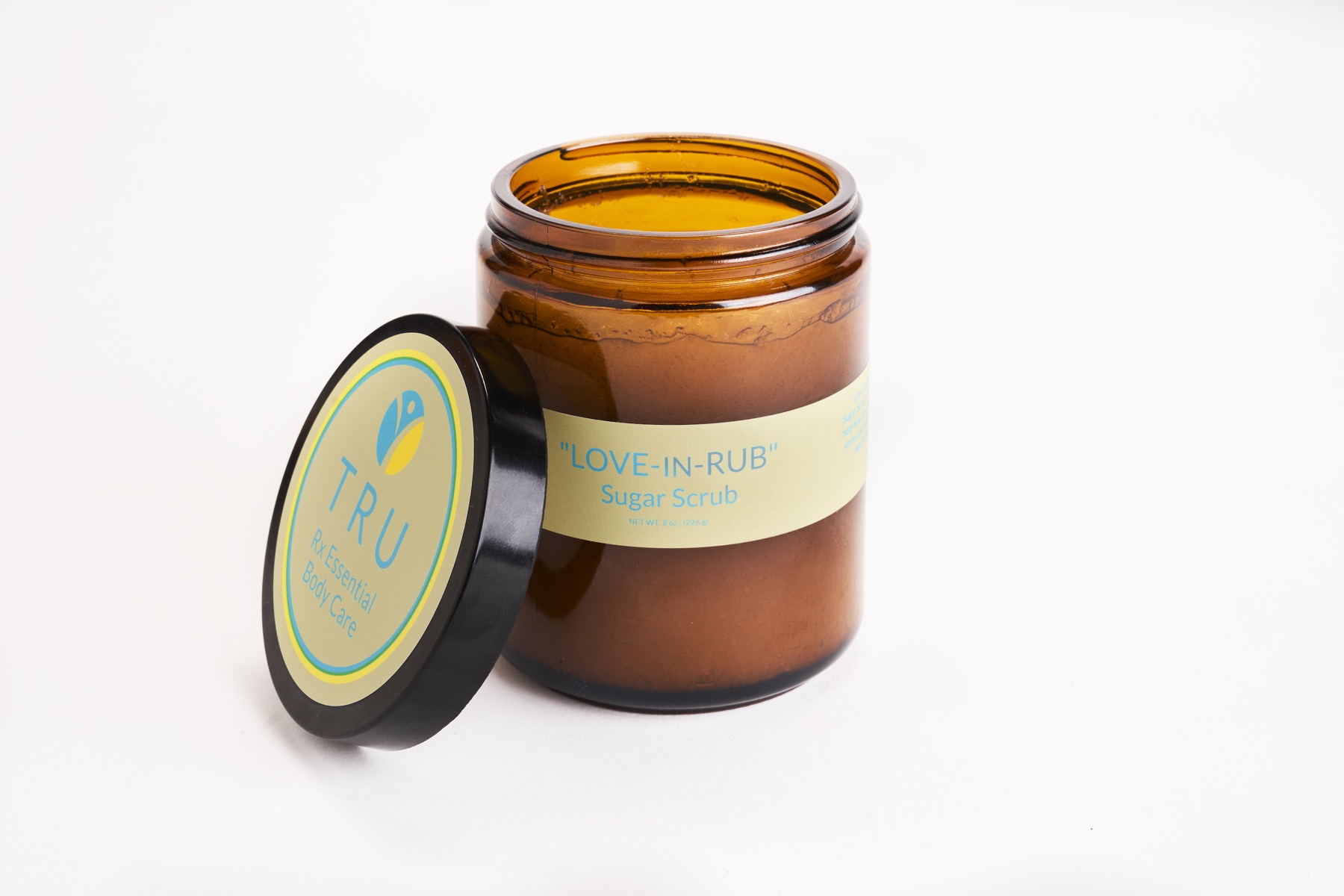 Rub In Love magnesium body scrub in an amber glass jar