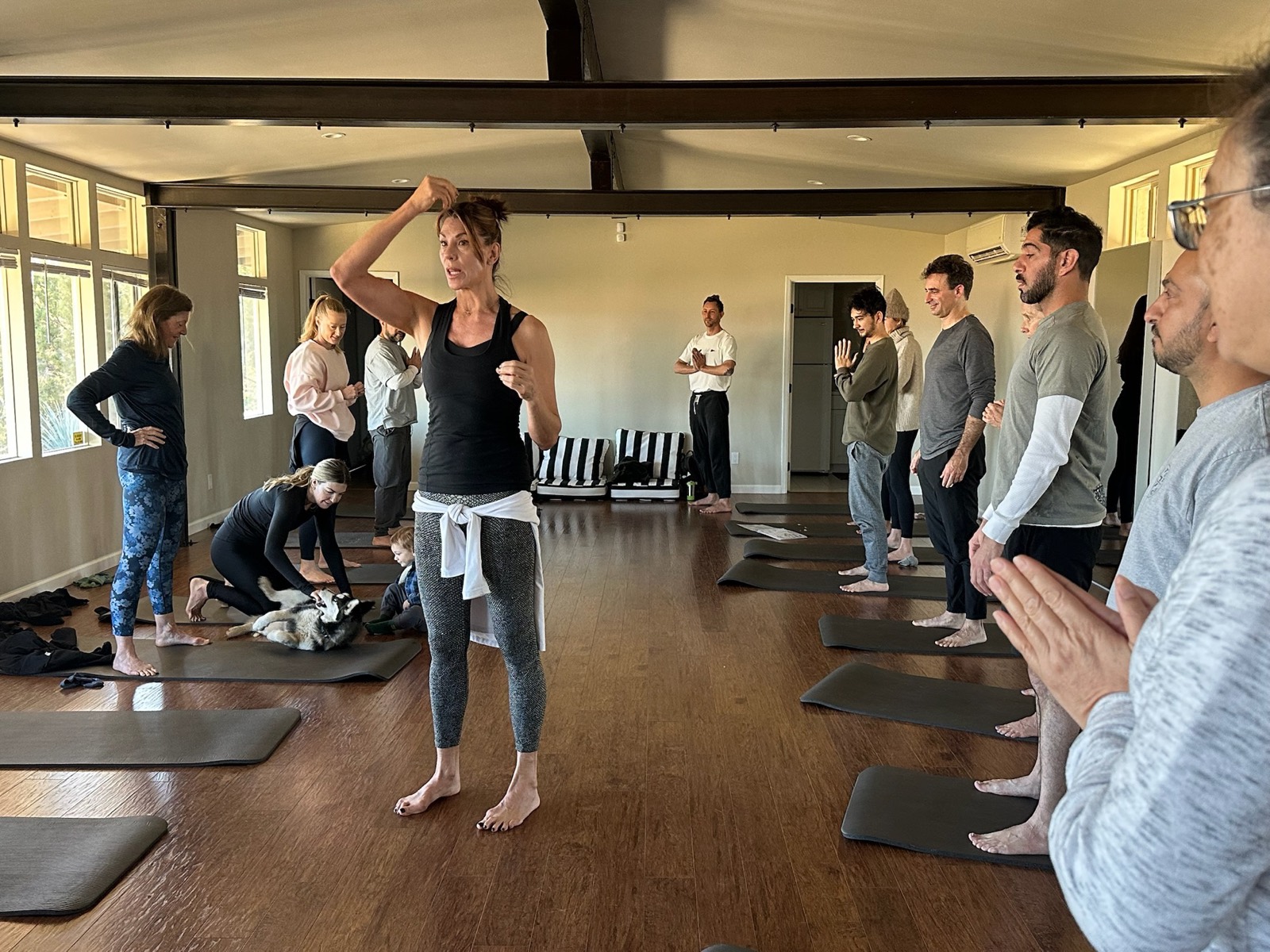 Alicia Gilbert guiding a TRU Core Method workshop with participants on mats in a sunlit studio